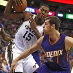 Utah Jazz' Derrick Favors, left, grabs a rebound from Phoenix Suns' Goran Dragic during the second half of an NBA basketball game in Salt Lake City, Saturday, Nov. 1, 2014. The Jazz defeated the Suns 118-91. (AP Photo/George Frey)