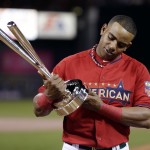  American League's Yoenis Cespedes, of the Oakland Athletics, holds the trophy after winning the MLB All-Star baseball Home Run Derby, Monday, July 14, 2014, in Minneapolis. Cespedes defeated National League's Todd Frazier, of the Cincinnati Reds, in the finals. (AP Photo/Jeff Roberson)