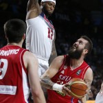 Serbia's Miroslav Raduljica drives the ball to the basket against United States' DeMarcus Cousins during the final World Basketball match between the United States and Serbia at the Palacio de los Deportes stadium in Madrid, Spain, Sunday, Sept. 14, 2014. (AP Photo/Daniel Ochoa de Olza)