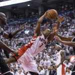Toronto Raptors' Kyle Lowry is fouled by Brooklyn Nets' Kevin Garnett, left, as Nets' Alan Anderson watches during the first half of Game 1 of an opening-round NBA basketball playoff series, in Toronto on Saturday, April 19, 2014. (AP Photo/The Canadian Press, Chris Young)
