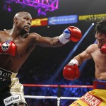 Floyd Mayweather Jr., left, trades blows with Manny Pacquiao, from the Philippines, during their welterweight title fight on Saturday, May 2, 2015 in Las Vegas. (AP Photo/John Locher)