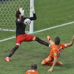  Mexico's goalkeeper Guillermo Ochoa makes a save after a shot by Netherlands' Klaas-Jan Huntelaar during the World Cup round of 16 soccer match between the Netherlands and Mexico at the Arena Castelao in Fortaleza, Brazil, Sunday, June 29, 2014. (AP Photo/Themba Hadebe)