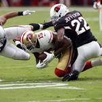 San Francisco 49ers wide receiver Michael Crabtree (15) is hit by Arizona Cardinals middle linebacker Larry Foote (50) and Tony Jefferson (22) during the first half of an NFL football game, Sunday, Sept. 21, 2014, in Glendale, Ariz. (AP Photo/Ross D. Franklin)