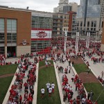 Fans wait in line to walk through metal detectors as they enter Great American Ball Park before the start of the Cincinnati Reds-Pittsburgh Pirates Opening day baseball game played Monday, April 6, 2015 in Cincinnati. Metal detectors are now in use at all Major League ball parks. (AP Photo/Gary Landers)