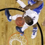 Kentucky center Dakari Johnson, top, fights for a rebound with Connecticut center Amida Brimah during the first half of the NCAA Final Four tournament college basketball championship game Monday, April 7, 2014, in Arlington, Texas. (AP Photo/David J. Phillip)