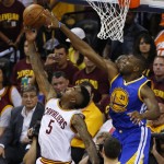 Golden State Warriors center Festus Ezeli (31) blocks the shot of Cleveland Cavaliers guard J.R. Smith (5) during the first half of Game 6 of basketball's NBA Finals in Cleveland, Tuesday, June 16, 2015. (AP Photo/Paul Sancya)
