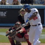 Los Angeles Dodgers' Yasiel Puig, right, hits a three-run home run as Arizona Diamondbacks catcher Miguel Montero catches during the sixth inning of a baseball game, Sunday, April 20, 2014, in Los Angeles. (AP Photo/Mark J. Terrill)