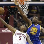 Golden State Warriors center Festus Ezeli (31) blocks the shot of Cleveland Cavaliers guard J.R. Smith (5) during the first half of Game 6 of basketball's NBA Finals in Cleveland, Tuesday, June 16, 2015. (AP Photo/Tony Dejak)
