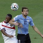 Costa Rica's Junior Diaz, left, and Uruguay's Christian Stuani go for a header during the group D World Cup soccer match between Uruguay and Costa Rica at the Arena Castelao in Fortaleza, Brazil, Saturday, June 14, 2014. (AP Photo/Sergei Grits)