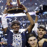 Connecticut forward DeAndre Daniels holds up the championship trophy after beating Kentucky 60-54, at the NCAA Final Four tournament college basketball championship game Monday, April 7, 2014, in Arlington, Texas. (AP Photo/David J. Phillip)