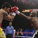 Floyd Mayweather Jr., right, trades blows with Manny Pacquiao, from the Philippines, during their welterweight title fight on Saturday, May 2, 2015 in Las Vegas. (AP Photo/Isaac Brekken)