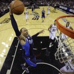 Dallas Mavericks' Shawn Marion (0) drives to the basket over San Antonio Spurs' Tony Parker (9), of France, during the first half of Game 2 of the opening-round NBA basketball playoff series on Wednesday, April 23, 2014, in San Antonio. (AP Photo/Eric Gay)