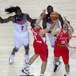 Serbia's Nemanja Bjelica, center, and Serbia's Nikola Kalinic, and United States' Kenneth Faried, left, vie for the ball during the final World Basketball match between the United States and Serbia at the Palacio de los Deportes stadium in Madrid, Spain, Sunday, Sept. 14, 2014. (AP Photo/Manu Fernandez)