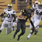 Arizona State quarterback Mike Bercovici scrambles as UCLA defensive lineman Owamagbe Odighizuwa (94) and linebacker Myles Jack (30) pursue during the first half of an NCAA college football game, Thursday, Sept. 25, 2014, in Tempe, Ariz. (AP Photo/Rick Scuteri)