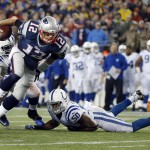New England Patriots quarterback Tom Brady (12) gets away from Indianapolis Colts defensive end Arthur Jones (97) and linebacker Jerrell Freeman (50) during the first half of the NFL football AFC Championship game Sunday, Jan. 18, 2015, in Foxborough, Mass. (AP Photo/Elise Amendola)