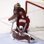 Arizona Coyotes' Mike Smith is unable to make a glove side on a shot by Buffalo Sabres' Andrej Meszaros, of the Czech Republic, for his second goal during the second period of an NHL hockey game Monday, March 30, 2015, in Glendale, Ariz. (AP Photo/Ross D. Franklin)