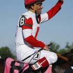  Jockey Javier Castellano waves to the crowd after winning the 113th running of the Manhattan horse race aboard Real Solution at Belmont Park, Saturday, June 7, 2014, in Elmont, N.Y. (AP Photo/Matt Slocum)