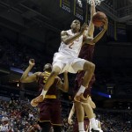  Texas' Demarcus Holland (2) drives to the basket against Arizona State's Jermaine Marshall, left, and Jordan Bachynski during the second half of a second-round game in the NCAA college basketball tournament Thursday, March 20, 2014, in Milwaukee. (AP Photo/Morry Gash)