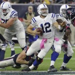 Indianapolis Colts' Andrew Luck (12) is tripped up by Houston Texans' J.J. Watt (99) during the second half of an NFL football game, Thursday, Oct. 9, 2014, in Houston. (AP Photo/David J. Phillip)