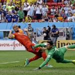 Belgium's Vincent Kompany backs away as goalkeeper Thibaut Courtois dives on a wide shot by Argentina's Ezequiel Garay during the World Cup quarterfinal soccer match at the Estadio Nacional in Brasilia, Brazil, Saturday, July 5, 2014. (AP Photo/Kirsty Wigglesworth)