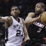  Miami Heat guard Dwyane Wade (3) looks to pass as San Antonio Spurs forward Tim Duncan (21) defends during the first half in Game 5 of the NBA basketball finals on Sunday, June 15, 2014, in San Antonio. (AP Photo/David J. Phillip)
