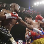 Floyd Mayweather Jr., left, trades punches with Manny Pacquiao, from the Philippines, during their welterweight title fight on Saturday, May 2, 2015 in Las Vegas. (AP Photo/Isaac Brekken)