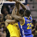 Cleveland Cavaliers guard J.R. Smith (5), left, blocks the shot over Golden State Warriors forward Draymond Green (23) during the first half of Game 4 of basketball's NBA Finals in Cleveland, Thursday, June 11, 2015. (AP Photo/Tony Dejak)