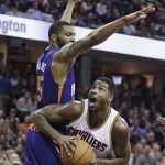 Cleveland Cavaliers' Tristan Thompson, right, from Canada, tries to get past Phoenix Suns' Marcus Morris during the second quarter of an NBA basketball game Saturday, March 7, 2015, in Cleveland. (AP Photo/Tony Dejak)