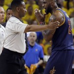 Cleveland Cavaliers forward LeBron James, right, talks with an official during the first half of Game 5 of basketball's NBA Finals against the Golden State Warriors in Oakland, Calif., Sunday, June 14, 2015. (AP Photo/Ben Margot)
