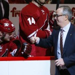 New Arizona Coyotes majority owner Andrew Barroway, right, fist pumps team members, including Mikkel Boedker (89), of Denmark, after Barroway dropped the ceremonial first puck prior to an NHL hockey game against the Columbus Blue Jackets Saturday, Jan. 3, 2015, in Glendale, Ariz. (AP Photo/Ross D. Franklin)