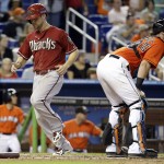 Arizona Diamondbacks' Ender Inciarte, left, scores on a double hit by Mark Trumbo in the sixth inning during a baseball game against the Miami Marlins, Sunday, Aug. 17, 2014, in Miami. At right is Miami Marlins catcher Jarrod Saltalamacchia, (AP Photo/Lynne Sladky)