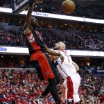 Toronto Raptors forward Terrence Ross (31) dunks over Washington Wizards center Marcin Gortat (4), from Poland, during the first half of Game 3 in the first round of the NBA basketball playoffs Friday, April 24, 2015, in Washington. (AP Photo/Alex Brandon)