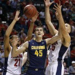 California's David Kravish, center, battles for a rebound with Arizona's Brandon Ashley, left, and Arizona's Kaleb Tarczewski, right, in the first half of an NCAA college basketball game in the quarterfinals of the Pac-12 conference tournament Thursday, March 12, 2015, in Las Vegas. (AP Photo/John Locher)