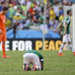  Mexico's Javier Aquino lies on the pitch after the Netherlands defeated Mexico 2-1 to advance to the quarterfinals during the World Cup round of 16 soccer match between the Netherlands and Mexico at the Arena Castelao in Fortaleza, Brazil, Sunday, June 29, 2014. (AP Photo/Felipe Dana)