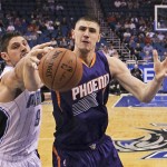 Orlando Magic's Nikola Vucevic (9) and Phoenix Suns' Alex Len, right, battle for a rebound during the first half of an NBA basketball game, Wednesday, March 4, 2015, in Orlando, Fla. (AP Photo/John Raoux)