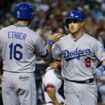 Los Angeles Dodgers' Yasmani Grandal (9) high fives teammate Andre Ethier (16)after hitting a two run home run against the Arizona Diamondbacks during the second inning of a baseball game, Tuesday, June 30, 2015, in Phoenix. (AP Photo/Matt York)