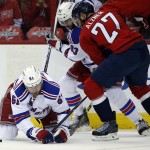 New York Rangers defenseman Keith Yandle (93) and Washington Capitals defenseman Karl Alzner (27) work the puck in front of left wing Rick Nash (61) during the second period of Game 3 in the second round of the NHL Stanley Cup hockey playoffs, Monday, May 4, 2015, in Washington. (AP Photo/Alex Brandon)