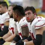 San Francisco 49ers players watch from the bench during the second half of an NFL football game against the Arizona Cardinals, Sunday, Sept. 21, 2014, in Glendale, Ariz. The Cardinals won 23-14. (AP Photo/Ross D. Franklin)