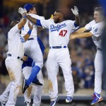 Los Angeles Dodgers' Howie Kendrick (47) celebrates his walk off single that scored Yasiel Puig with teammates in the ninth inning of a baseball game against the Arizona Diamondbacks, Wednesday, June 10, 2015, in Los Angeles. (AP Photo/Mark J. Terrill)
