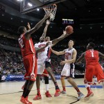 Arizona forward Rondae Hollis-Jefferson, second from left, shoots against Ohio State forward Sam Thompson, left, during an NCAA college basketball tournament round of 32 game in Portland, Ore., Saturday, March 21, 2015. At right are Arizona center Kaleb Tarczewski (35) and Ohio State forward Jae'Sean Tate (1). (AP Photo/Craig Mitchelldyer)