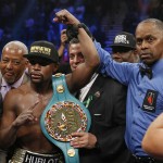Floyd Mayweather Jr., left, holds up the title belt next to referee Kenny Bayless after his win against Manny Pacquiao, from the Philippines, in their welterweight title fight on Saturday, May 2, 2015 in Las Vegas. (AP Photo/John Locher)