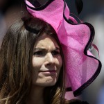 A fan watches a race before the 141st running of the Kentucky Oaks horse race at Churchill Downs Friday, May 1, 2015, in Louisville, Ky. (AP Photo/Darron Cummings)