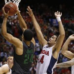 Oregon's Dillon Brooks, left, shoots over Arizona's Elliott Pitts, center, and Arizona's Gabe York during the first half of an NCAA college basketball game in the championship of the Pac-12 conference tournament Saturday, March 14, 2015, in Las Vegas. (AP Photo/John Locher)