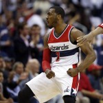 Washington Wizards guard John Wall (2) celebrates after a basket during the first half of Game 3 in the first round of the NBA basketball playoffs against the Toronto Raptors, Friday, April 24, 2015, in Washington. (AP Photo/Alex Brandon)