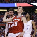 Wisconsin's Sam Dekker (15) and teammate Frank Kaminsky, left, celebrate in front of Duke's Matt Jones, right, during the first half of the NCAA Final Four college basketball tournament championship game Monday, April 6, 2015, in Indianapolis. (AP Photo/David J. Phillip)