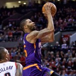 Phoenix Suns forward Marcus Morris, right, shoots over Portland Trail Blazers guard Damian Lillard, left, during the second quarter of an NBA basketball game in Portland, Ore., Monday, March 30, 2015. (AP Photo/Craig Mitchelldyer)