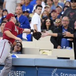 Arizona Diamondbacks first baseman Paul Goldschmidt, left, can't hold on to a foul ball hit by Los Angeles Dodgers' Yasiel Puig during the first inning of a baseball game, Wednesday, June 10, 2015, in Los Angeles. (AP Photo/Mark J. Terrill)