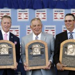  National Baseball Hall of Fame inductees Tom Glavine, left, Bobby Cox and Greg Maddux, right, hold their plaques after an induction ceremony at the Clark Sports Center on Sunday, July 27, 2014, in Cooperstown, N.Y. (AP Photo/Mike Groll)