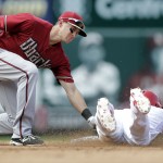 St. Louis Cardinals' Kolten Wong, right, is tagged out by Arizona Diamondbacks shortstop Nick Ahmed while attempting to steal second during the fifth inning of a baseball game Monday, May 25, 2015, in St. Louis. (AP Photo/Jeff Roberson)