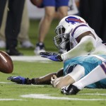 Buffalo Bills inside linebacker Preston Brown attempts to grab a ball fumbled by Miami Dolphins quarterback Ryan Tannehill during the first half of an NFL football game, Thursday, Nov. 13, 2014 in Miami Gardens, Fla. The ball was recovered by Bills strong safety Duke Williams. (AP Photo/Lynne Sladky)